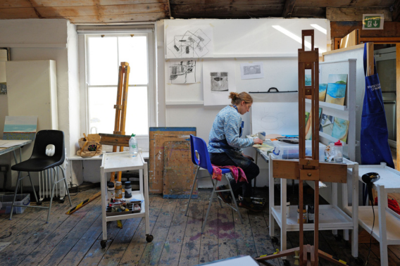student painting in an art studio during the porthmeor programme