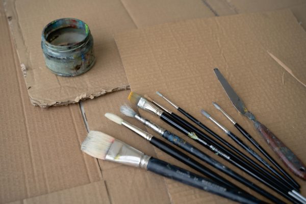 Paint brushes on cardboard ready for painting at home