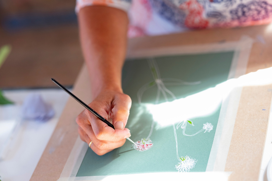 a woman painting by hand at st ives school of painting