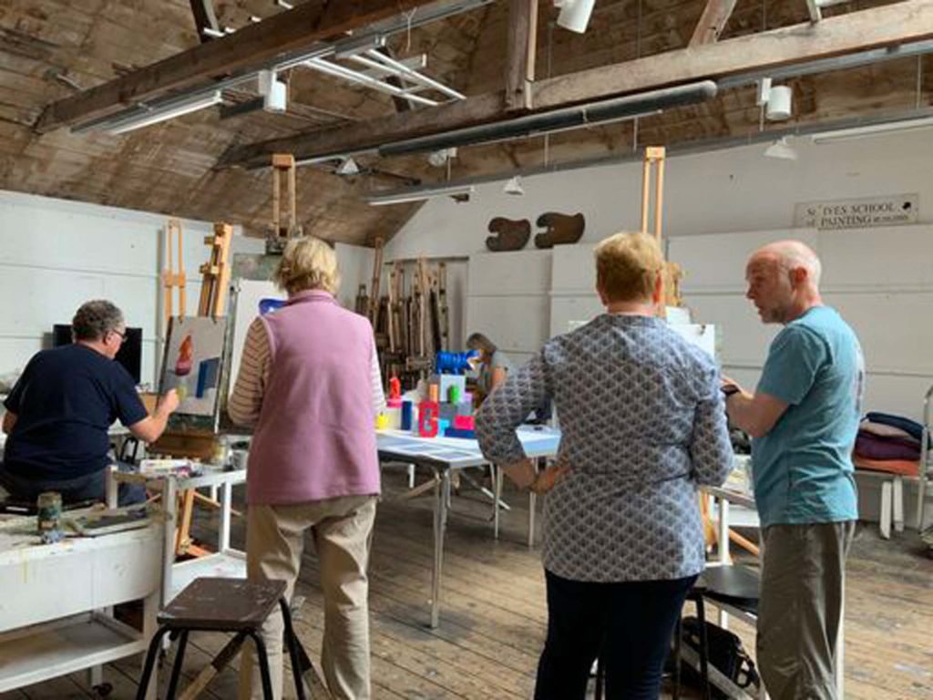 tutor with students in painting studio in St Ives working from still life