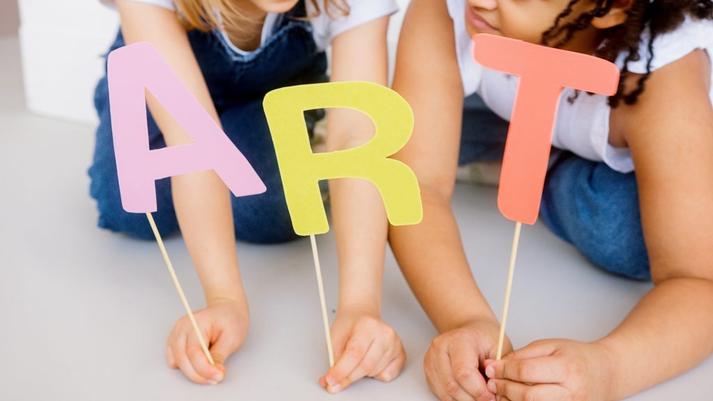 Sunday kids club 2 children hold art sign