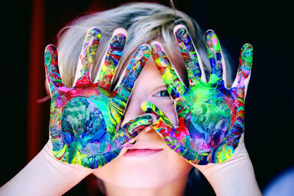 Sunday kids club child with painted hands